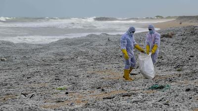 Sri Lankan soldiers remove debris from the 'MV X-Press Pearl' that washed ashore on a beach in Colombo. AFP