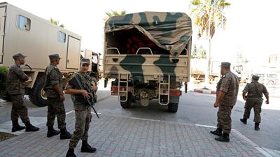Soldiers stand guard as military trucks transport ballot boxes and election material to be distributed to polling stations, ahead of the Sunday's parliamentary election, in Tunis, Tunisia October 5, 2019. Reuters