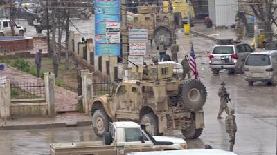 An image grab taken from a video obtained by AFPTV on January 16, 2019, shows US troops gathered at the scene of a suicide attack in the northern Syrian town of Manbij. A suicide attack targeting US-led coalition forces in the flashpoint northern Syrian city of Manbij killed a US serviceman and 14 other people today, a monitor said. / AFP / ANHA / -