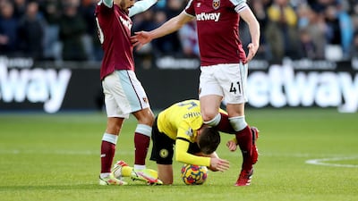 Chelsea midfielder Jorginho leans over the ball surrounded by West Ham's Declan Rice and Manuel Lanzini. Reuters