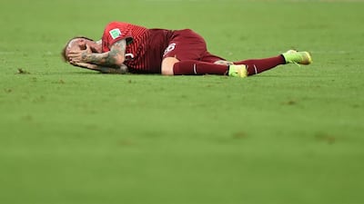 Raul Meireles lies on the pitch after picking up an injury. Marius Becker / EPA