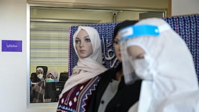 Mannequins showing past and present products made by Mother's Workshop stand in front of the administrative office of the garment factory in the Lebanese town of Saida. Finbar Anderson
