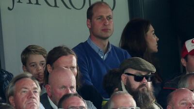 Britain's Prince William and Prince George in the stands during the match. Reuters