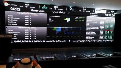 Above, a trader monitors stock information at the Tadawul in Riyadh. HSBC is the only foreign financial institution so far to confirm it has been licensed as a Qualified Foreign Investor. Faisal Al Nasser / Reuters