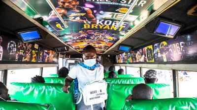 A woman boards a minibus from the Nairobi City Center to Kibera Slums in Nairobi, Kenya. Getty Images