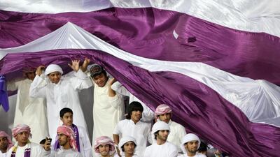 Al Ain 's fans celebrate under their giant flat at the Super Cup final in Dubai. (Jaime Puebla / The National)