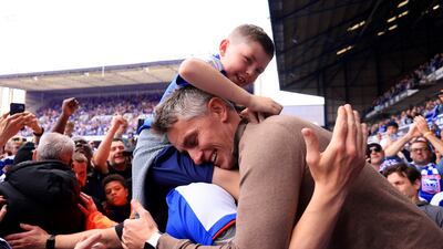 Ipswich manager Kieran McKenna celebrates with a young fan and his dad. Getty Images