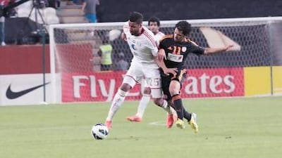 Khamis Ismail, left, tries keeping Ahmed Ibrahim Ateef of the Saudi Arabian side Al Shabab off the ball in their Asian Champions League match.