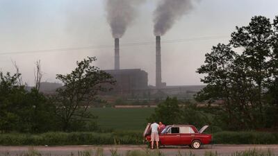 Motorists try to repair their Russian Lada on the motorway near a steel production plant in Mariupol, Ukraine. John Moore / Getty
