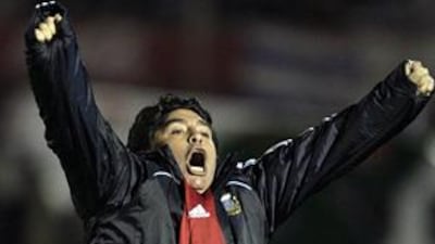 Diego Maradona celebrates Mario Bolatti's World Cup finals-clinching goal against Uruguay on Wednesday night.
