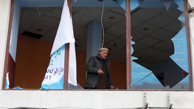 An Afghan shopkeeper removes the broken glass window of his shop near the site of the bomb attack in Kabul, Afghanistan, which killed 95 people. Omar Sobhani / Reuters