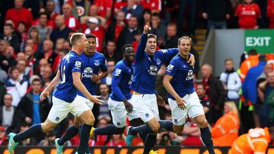 Phil Jagielka, right, celebrates with his Everton teammates after scoring the equaliser against Liverpool. Alex Livesey / Getty Images