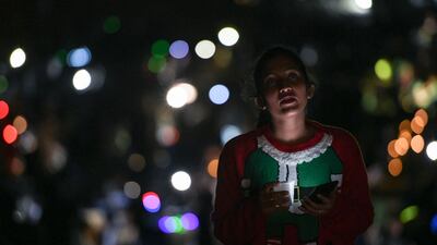 Young children participate in singing Christmas carols by candlelight in the desert. Khushnum Bhandari for The National