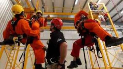 John Wisse, the training manager of Traks Pro, centre, supervises a rope training exercises in Dubai Investment Park.