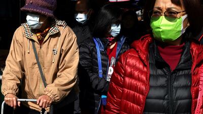 Customers wear protective masks while shopping at a market in Taipei, Taiwan. Reuters