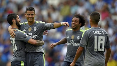 Real Madrid's Portuguese forward Cristiano Ronaldo (2ndL) celebrates with teammates Real Madrid's midfielder Isco (L) and Real Madrid's Brazilian defender Marcelo (2ndR) after scoring during the Spanish league football match RCD Espanyol vs Real Madrid CF at the Power8 stadium in Cornella de Llobregat on September 12, 2015. AFP PHOTO/ LLUIS GENE