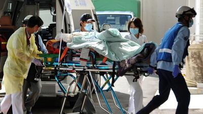 Many of those who made it down emerged with clothes and backpacks covered in ash. They reported being engulfed in total darkness for several minutes. Kyodo News / AP Photo