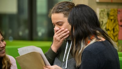 Souhaib Boettgenbach, centre, sees his GCSE results at Westminster Academy in London. Getty Images