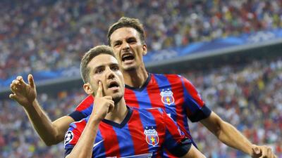 Steaua Bucharest's Alexandru Chipciu, left, reacts after scoring against Ludogorets Razgrad, with Lukasz Szukala, right, during their Uefa Champions League match on Tuesday. Robert Ghement / EPA