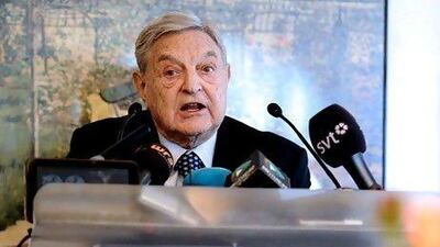 George Soros speaks to journalists at Davos. AFP