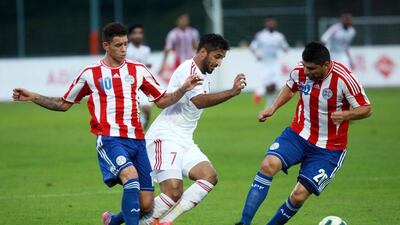 Paraguay striker Tonny Sanabria, left, and teammate Nestor Ortigoza converge on the UAE's Ali Mabkhout, centre, during their friendly at Villach, Austria, on September 7, 2014. DANIEL RAUNIG / AFP