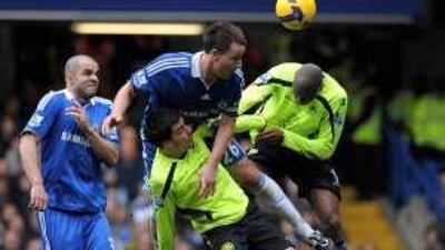 John Terry, centre, climbs above two Wigan players to head the ball away from danger during Chelsea's 2-1 Premier League victory at Stamford Bridge in February.