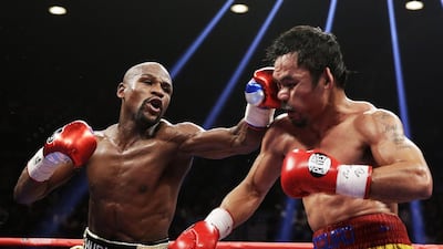 Floyd Mayweather, left, lands a sharp left on Manny Pacquiao during their welterweight title fight at the MGM Grand Garden Arena in Las Vegas. Mayweather won by unanimous points decision. Isaac Brekken / AP Photo