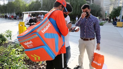 Visitors collecting food from the talabat rider at Expo 2020. Pawan Singh/The National.