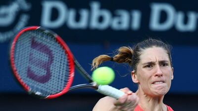 German Andrea Petkovic returns the ball to Italian Camila Giorgi during their WTA tennis match on the first day of the Dubai Duty Free Tennis Championships on February 16, 2016 in Dubai. / AFP / MARWAN NAAMANI