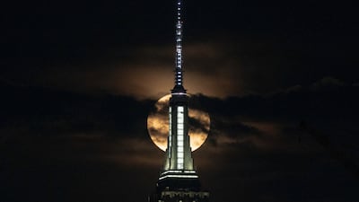 The supermoon, also known as the 'buck moon', rises over the New York City skyline. Reuters