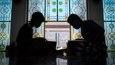 Indonesian Muslims read the Quran at the Sultan Mahmmud Baddarudin Mosque in Palembang, South Sumatra province. / AFP