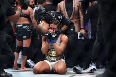 Mackenzie Dern sinks to her knees after being crowned UFC strawweight champion. Chris Whiteoak / The National