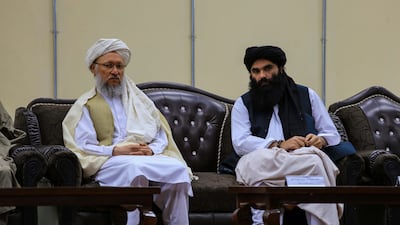 Taliban Second Deputy Prime Minister Abdul Salam Hanafi, left, and Interior Minister Sirajuddin Haqqani attend a ceremony to announce the ban on poppy cultivation. EPA
