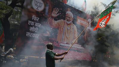 Bharatiya Janata Party (BJP) worker celebrate outside BJP headquarters in Mumbai, India. AP Photo