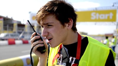 Muhammad Attia, operations manager of the American University of Sharjah team, communicates with driver Muhammad El Maud during a practice run. Jes Aznar for The National