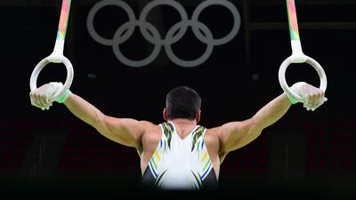 A Brazilian Olympic gymnast practices on the rings. Emmanuel Duband / AFP Photo