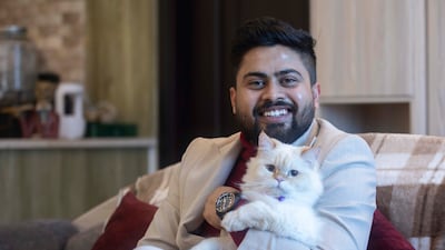 Shubhnam Hunda with his cat Ogie at his home in Dubai Sports City. All photos: Ruel Pableo / The National