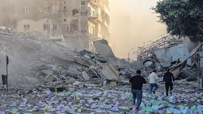 People rush to inspect the site of an Israeli air strike that targeted the offices of a Hezbollah-linked financial institution in the southern Lebanese city of Tyre. AFP