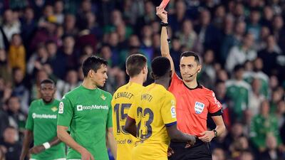 Referee Sanchez Martinez hands a red card to Barcelona's Clement Lenglet. AFP