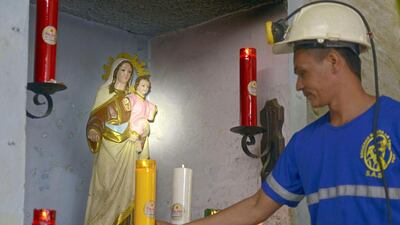 A miner lights a candle at 'La Primavera', a licensed gold mine in Segovia municipality. Raul Arboleda / AFP