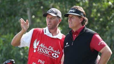 Phil Mickelson, right, consults with caddie Jim MacKay on the 17th tee on Saturday during the third round of the Abu Dhabi HSBC Golf Championship. Andrew Redington / Getty Images