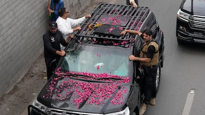 Security guards on the vehicle carrying former Pakistan prime minister Imran Khan from Lahore to Islamabad. AP