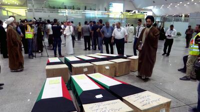 People gather near flag-draped coffins of Kuwaiti Shiite victims inside the hall of Najaf airport in southern Iraq, 28 June 2015 as some of those killed in the attack on a prominent Shiite mosque will be buried in the holy Shiite city of Najaf. Khider Abbas/EPA
