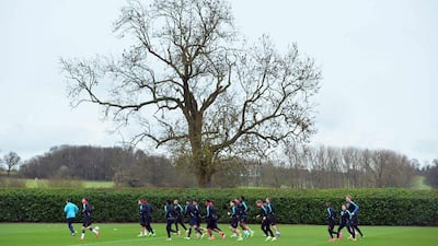 The Arsenal team attend a training session ahead of the UEFA Champions League round of 16 1st leg football match against Barcelona at Arsenal's London Colney training ground on February 22, 2016. Arsenal will play against Barcelona at the Emirates Stadium in London on Tuesday February 23, 2016. / AFP / GLYN KIRK