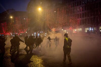 A protester stands in front of police during the 'yellow vests' demonstration near the Arc de Triomphe on December 8. Getty Images