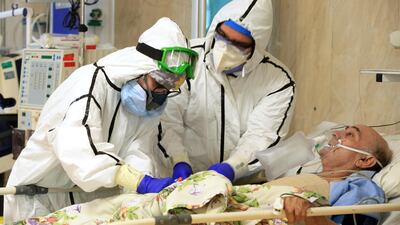 Medics tend to a Covid-19 patient at the Shohadaye Tajrish Hospital in Tehran, Iran. Iranian Health Ministry via AP