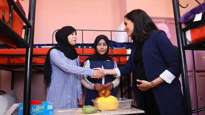 Meghan, Duchess of Sussex speaks to young girls as she visits the Education For All boarding house. Getty Images