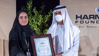 Sheikh Nahyan bin Mubarak, Minister of Culture, Youth, and Social Development, gives a Young Achievers Mother Teresa award to Mezna Al Mansoori. Victor Besa / The National