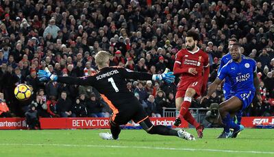 Liverpool's Mohamed Salah, centre, scores his side's second goal against Leicester City. Peter Byrne / PA
