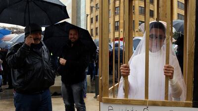 The Lebanese NGO Abaad put a bride in a cage during a protest against a rape law in the country which allows a rapist to avoid prison if he marries his victim / AP